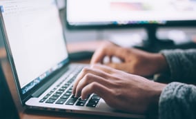 Typing on a laptop